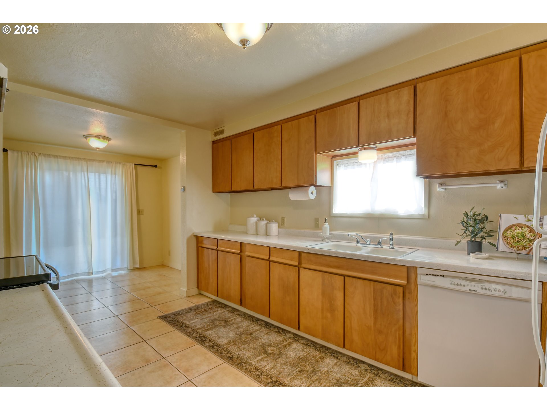 120 Southeast 7th Street Pendleton, OR 97801 - Photo 12 of 35 a kitchen with granite countertop a sink cabinets and window