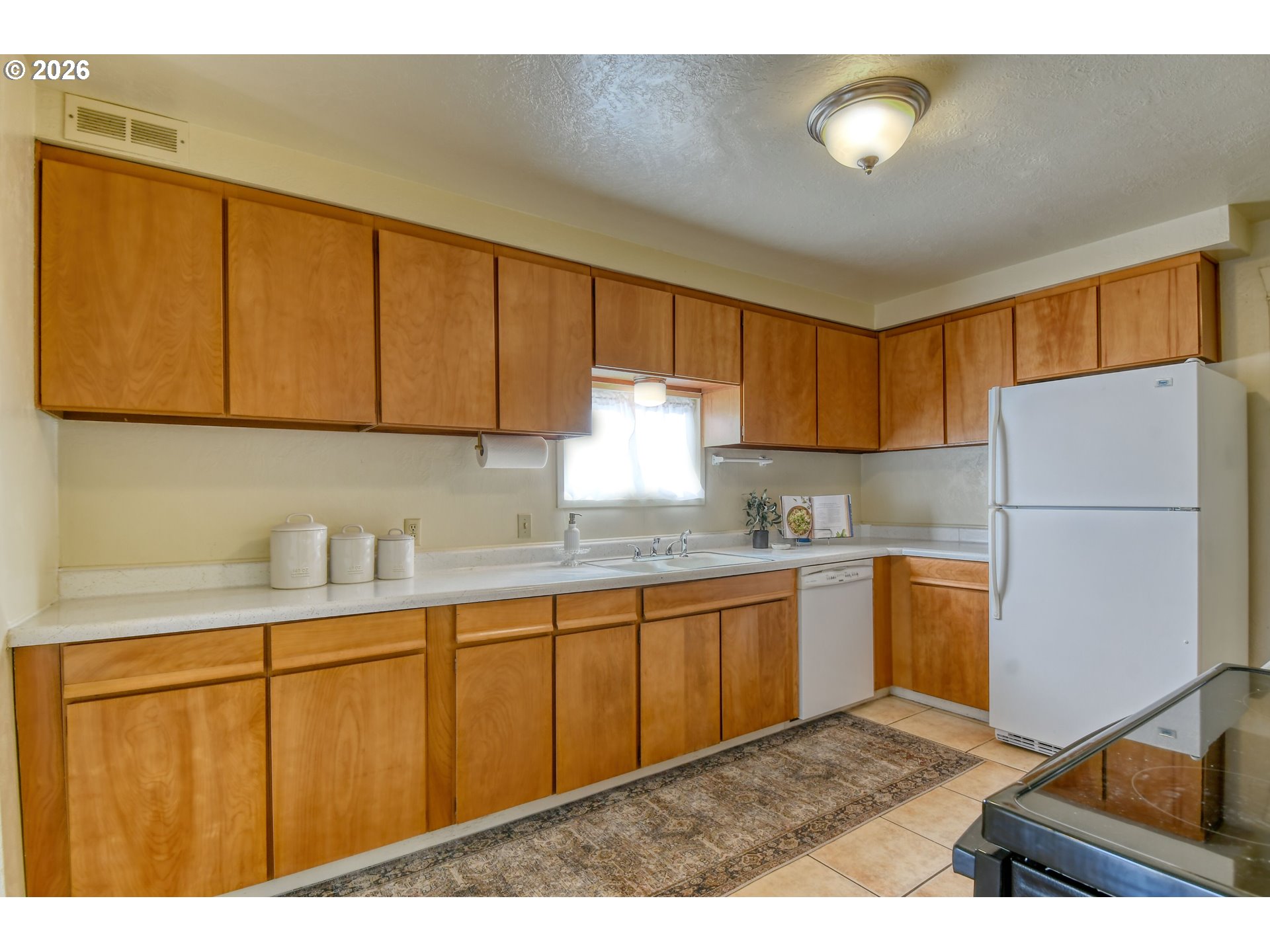120 Southeast 7th Street Pendleton, OR 97801 - Photo 15 of 35 a kitchen with granite countertop a sink stainless steel appliances and cabinets