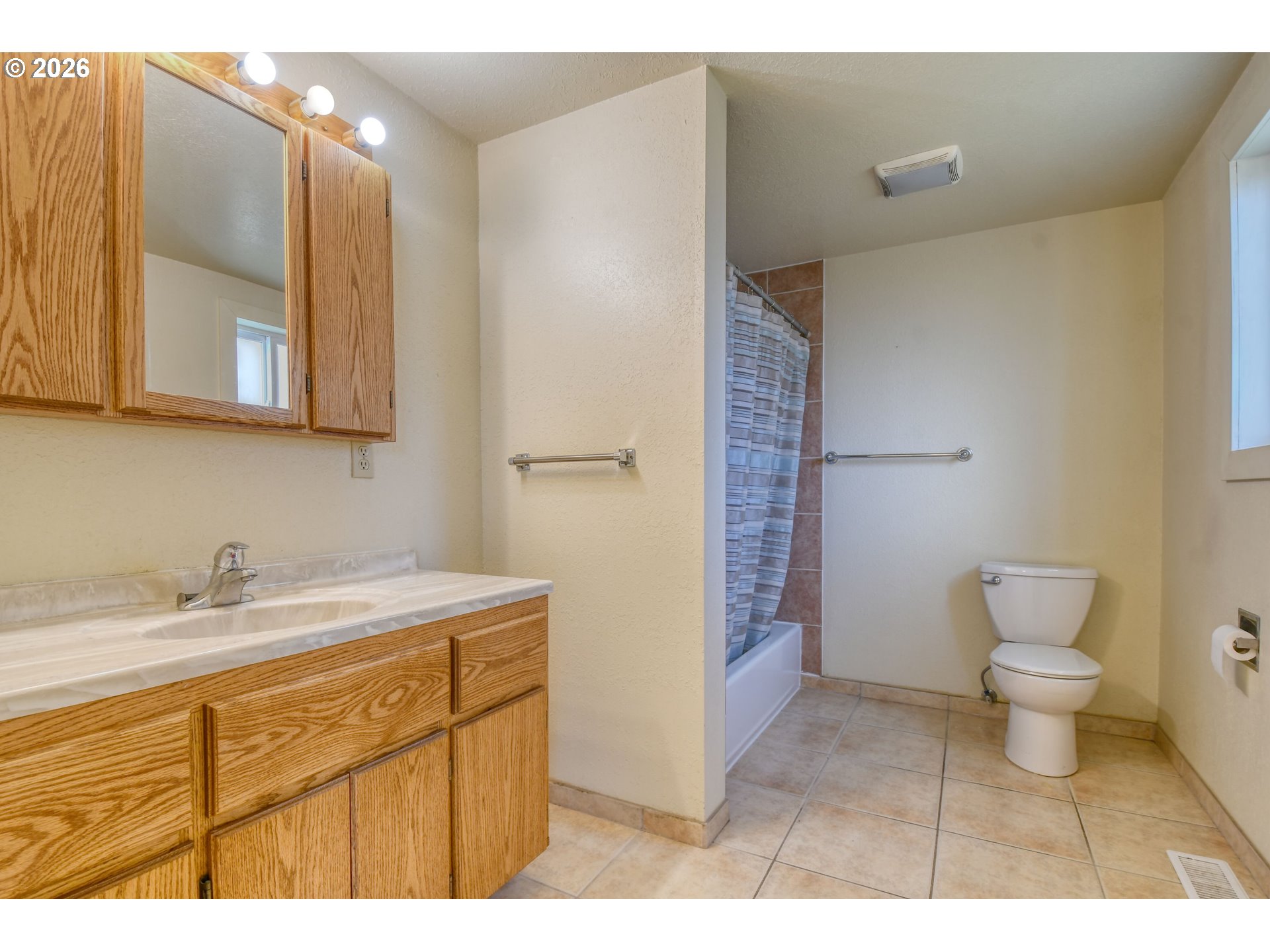 120 Southeast 7th Street Pendleton, OR 97801 - Photo 17 of 35 a bathroom with a sink a toilet and shower