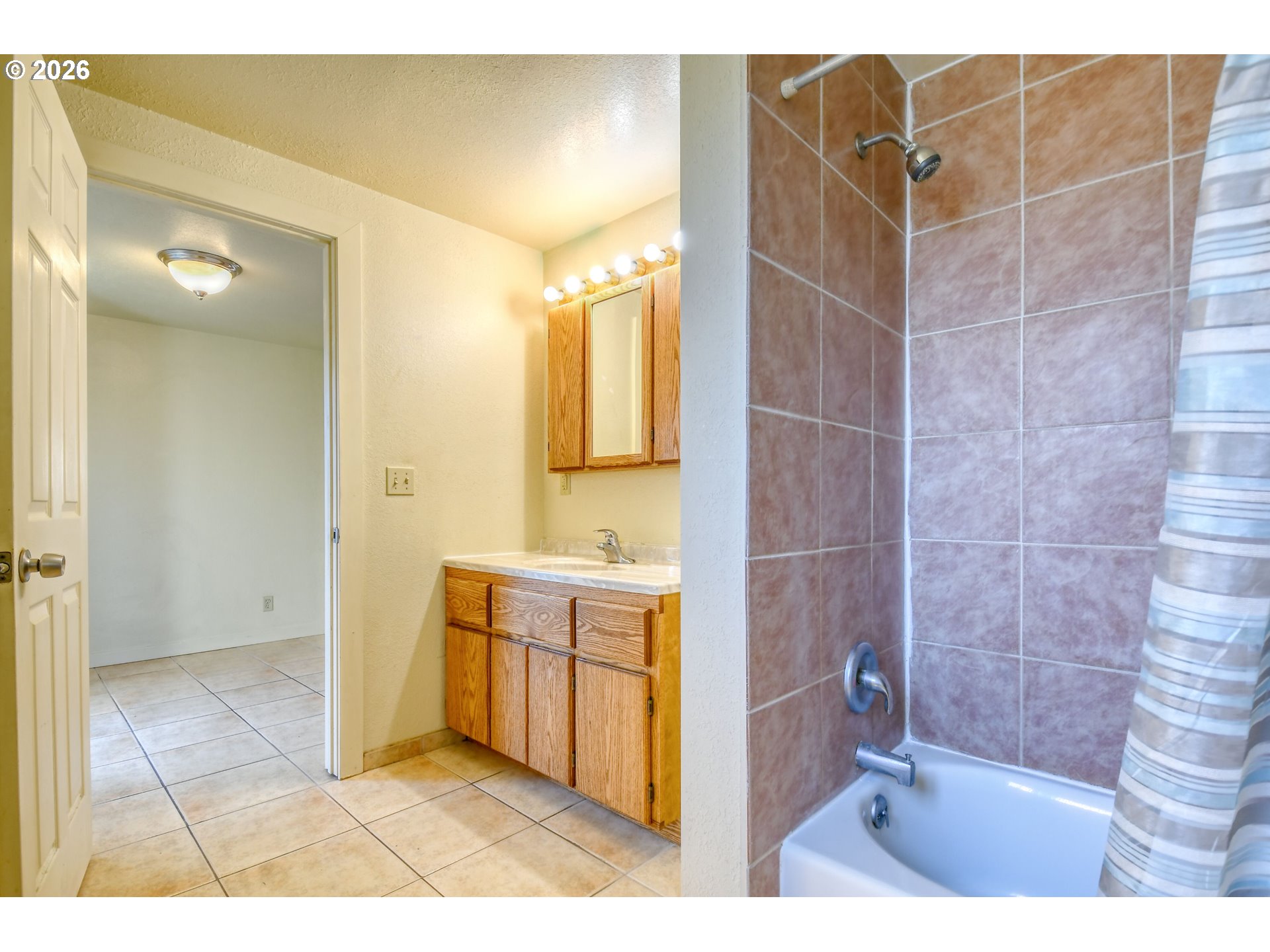 120 Southeast 7th Street Pendleton, OR 97801 - Photo 18 of 35 a bathroom with a granite countertop sink a mirror and a shower
