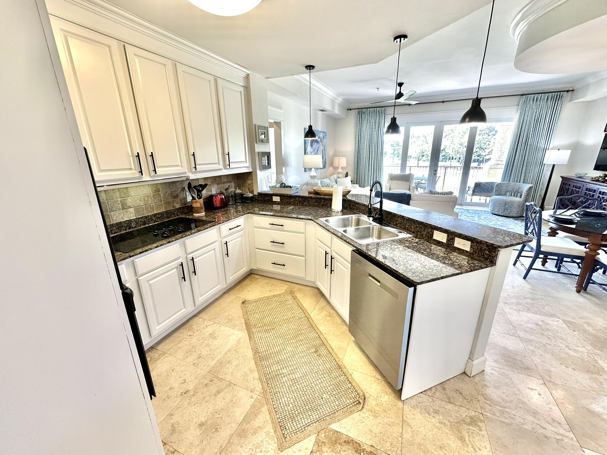 5353 Pine Ridge Lane, Unit 5353 Miramar Beach, FL 32550 - Photo 12 of 62 a kitchen with stainless steel appliances granite countertop a stove a sink and a refrigerator
