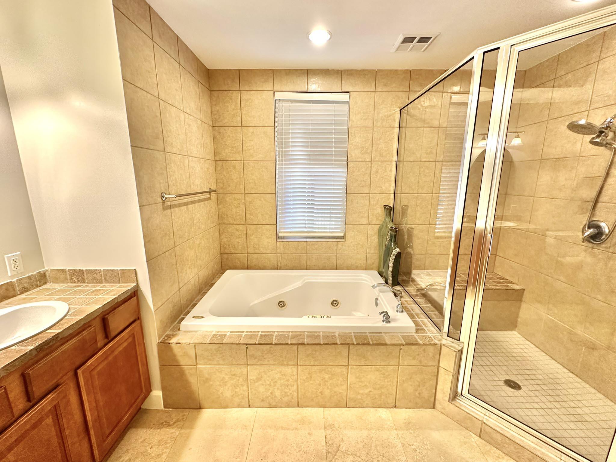 5353 Pine Ridge Lane, Unit 5353 Miramar Beach, FL 32550 - Photo 41 of 62 a bathroom with a tub a sink and a shower