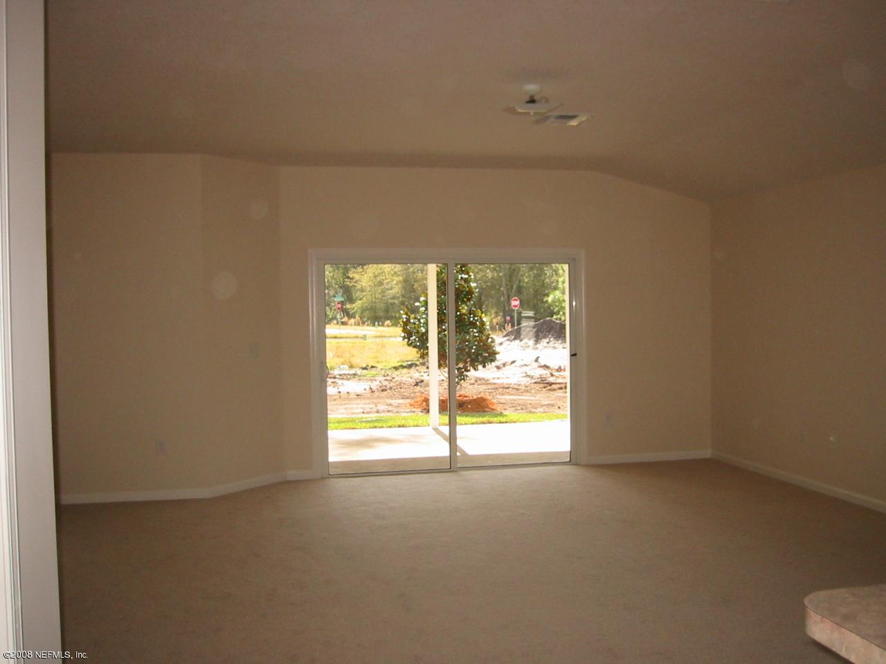 369 North Twin Maple Road St. Augustine, FL 32084 - Photo 2 of 9 a view of an empty room with a window