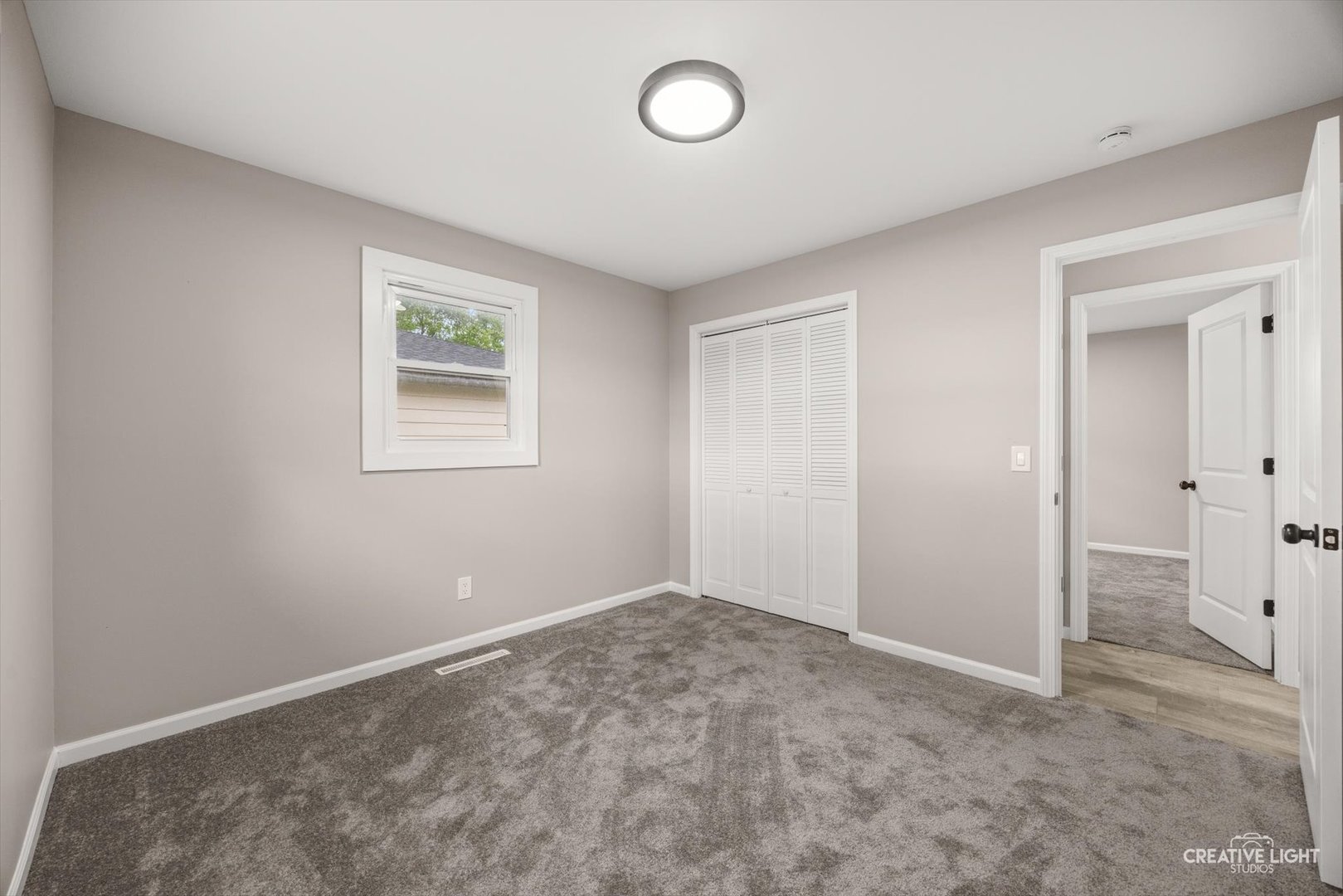 286 South Barbara Drive Kankakee, IL 60901 - Photo 14 of 18 an empty room with a cabinet and a window
