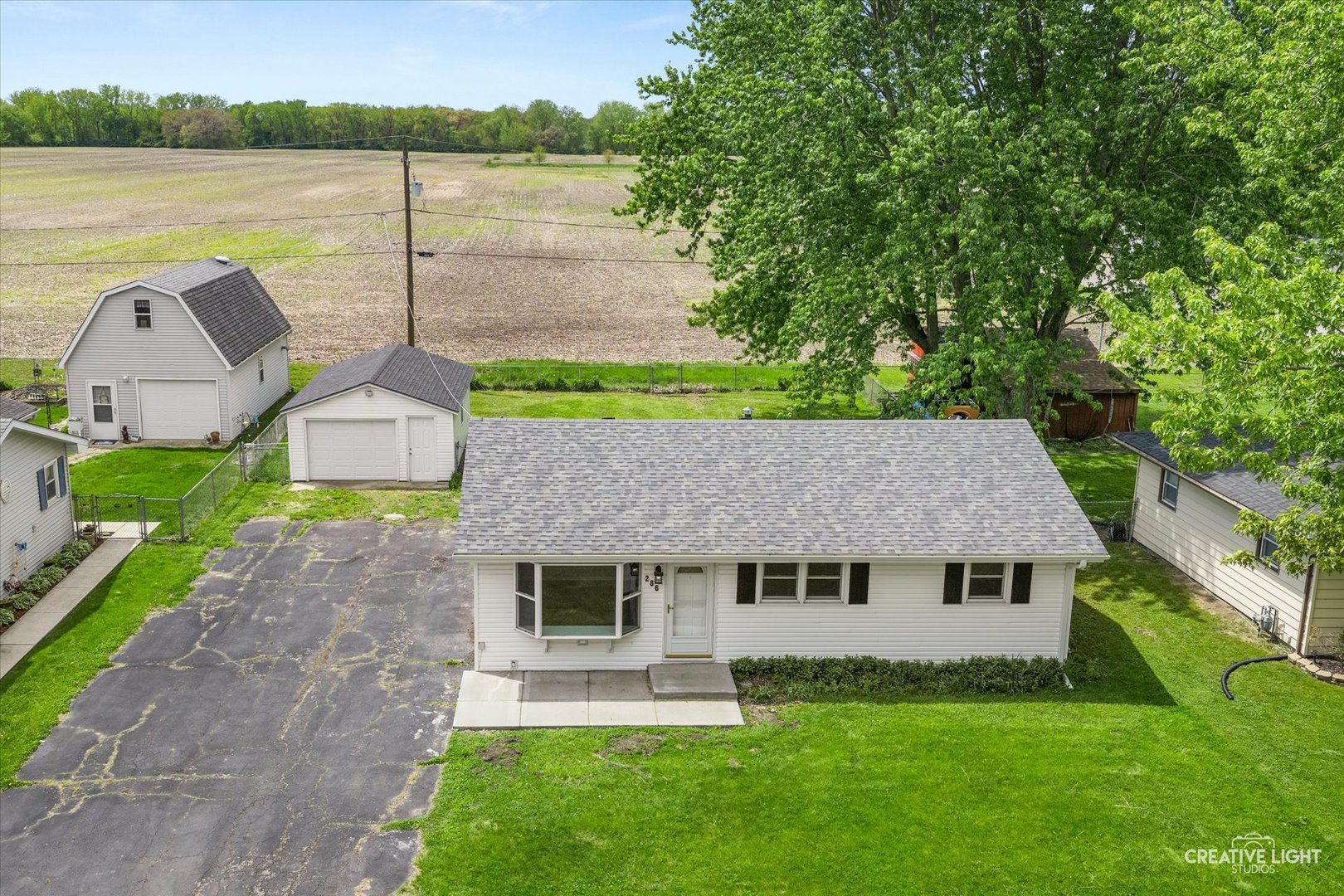 286 South Barbara Drive Kankakee, IL 60901 - Photo 3 of 18 a aerial view of a house next to a yard and large trees