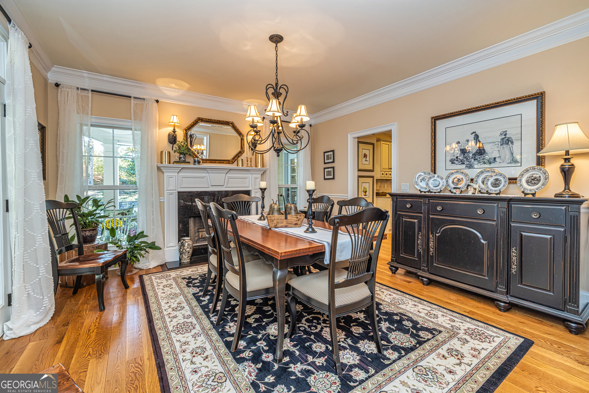 210 Mockingbird Lane Brooks, GA 30205 - Photo 14 of 87 a dining room with furniture a fireplace and a chandelier