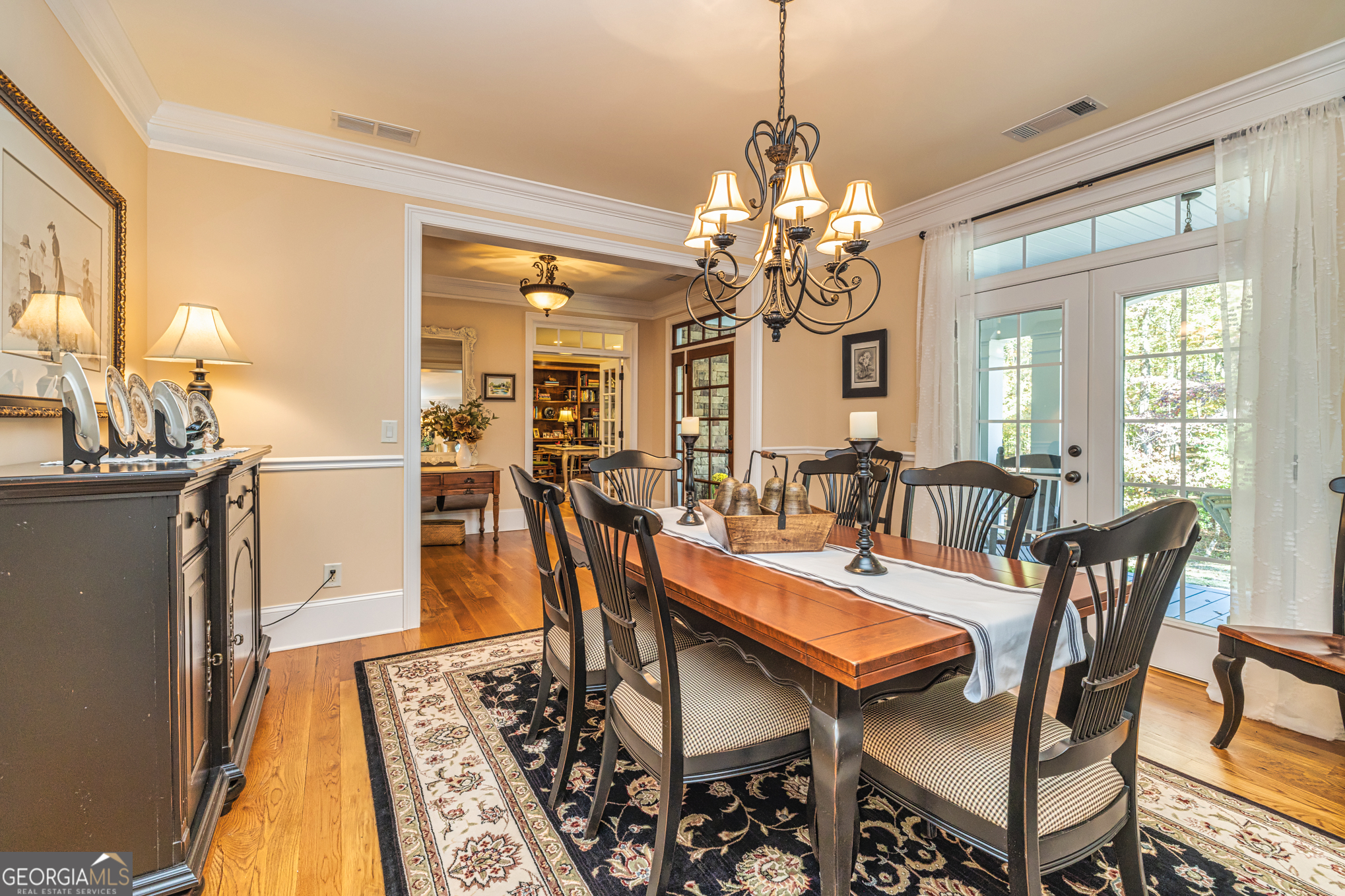 210 Mockingbird Lane Brooks, GA 30205 - Photo 16 of 87 a view of a dining room with furniture a chandelier and wooden floor