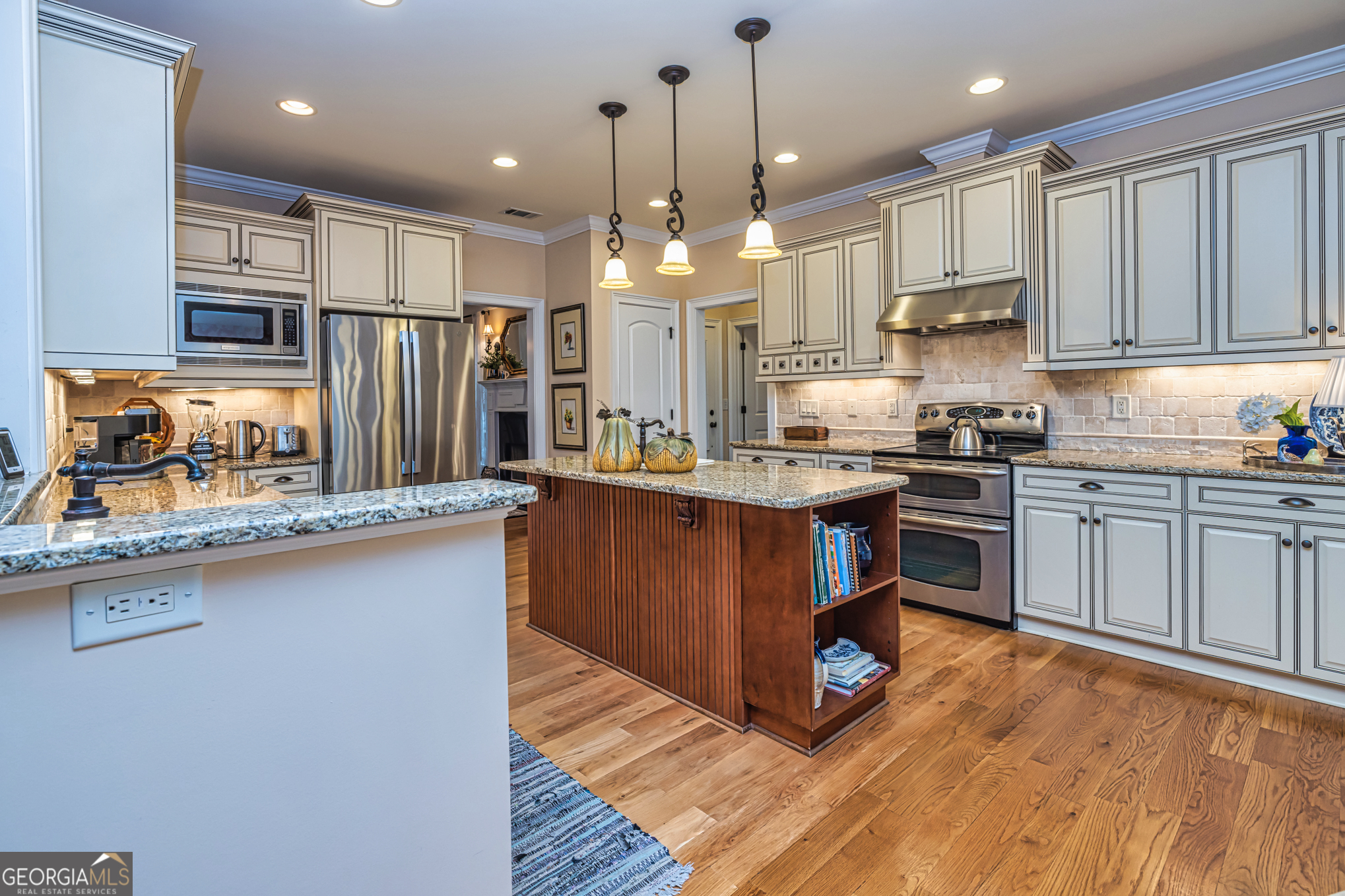 210 Mockingbird Lane Brooks, GA 30205 - Photo 24 of 87 a kitchen with kitchen island granite countertop a sink cabinets and stainless steel appliances