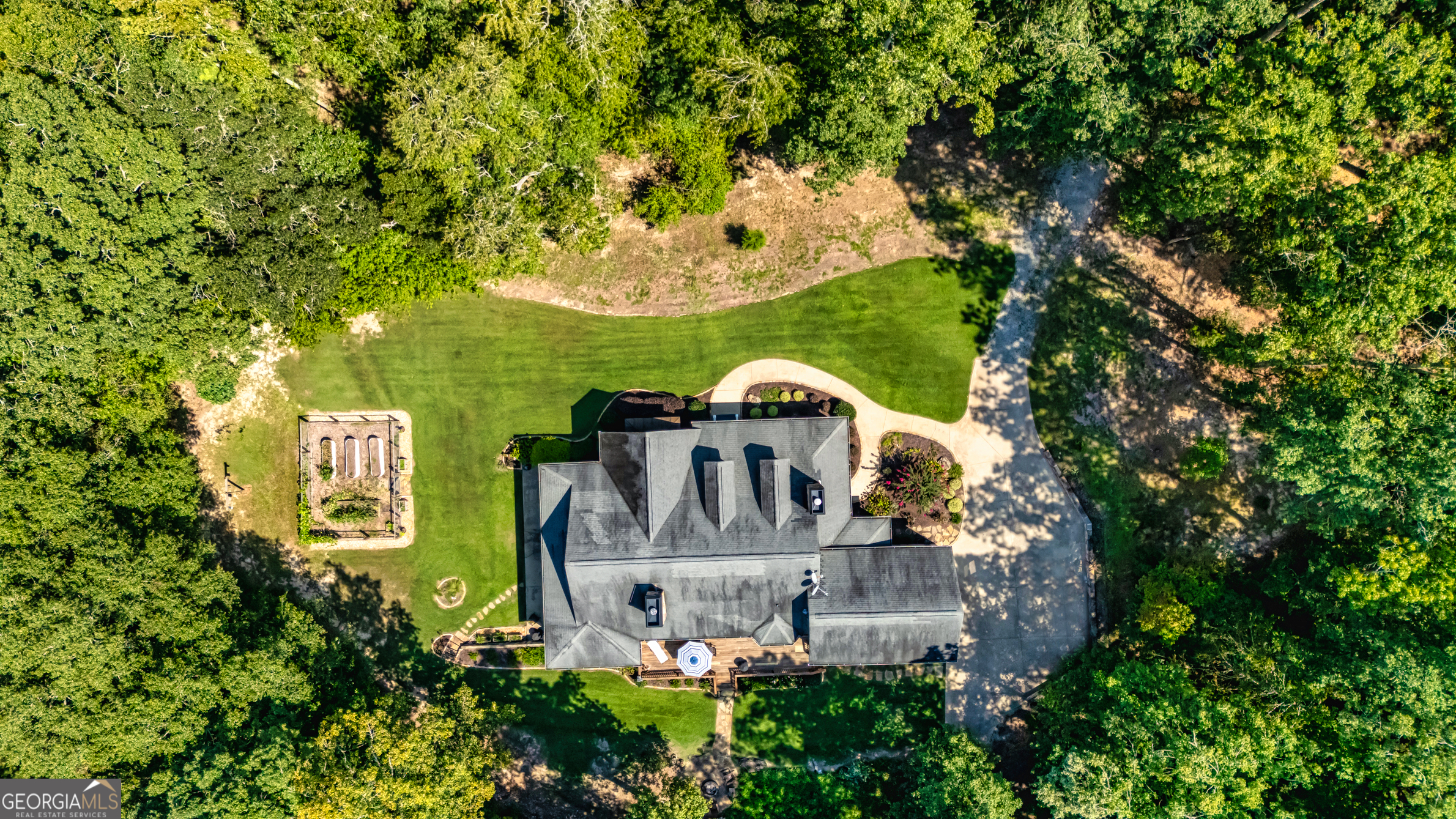 210 Mockingbird Lane Brooks, GA 30205 - Photo 76 of 87 an aerial view of a house with garden space sitting space and trees all around