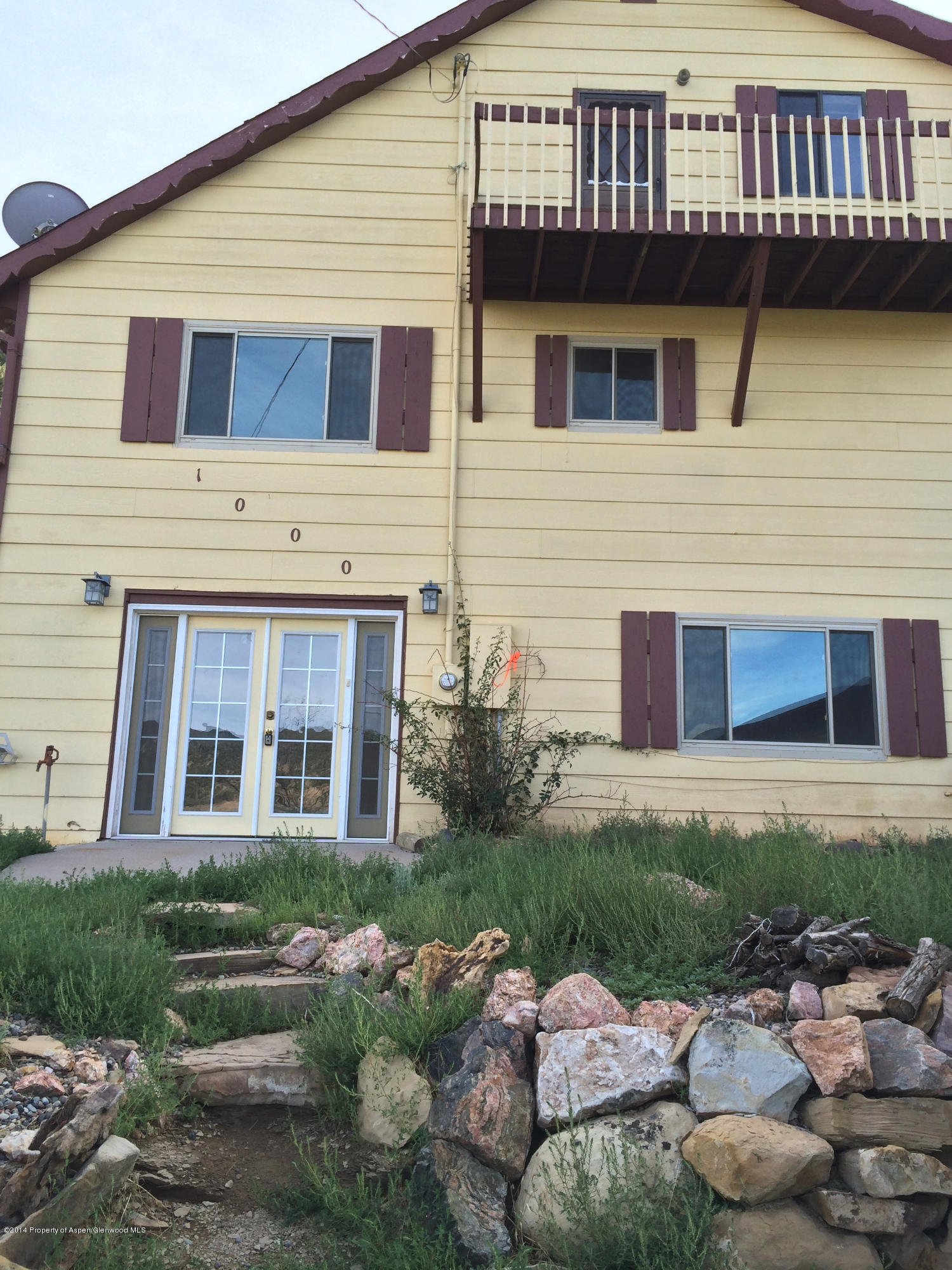 1000 County Road 252 Rifle, CO 81650 - Photo 2 of 22 a front view of a house with garden