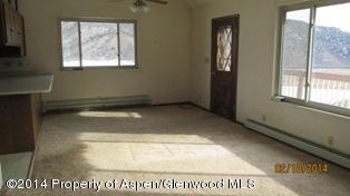 1000 County Road 252 Rifle, CO 81650 - Photo 7 of 22 a view of an empty room and window