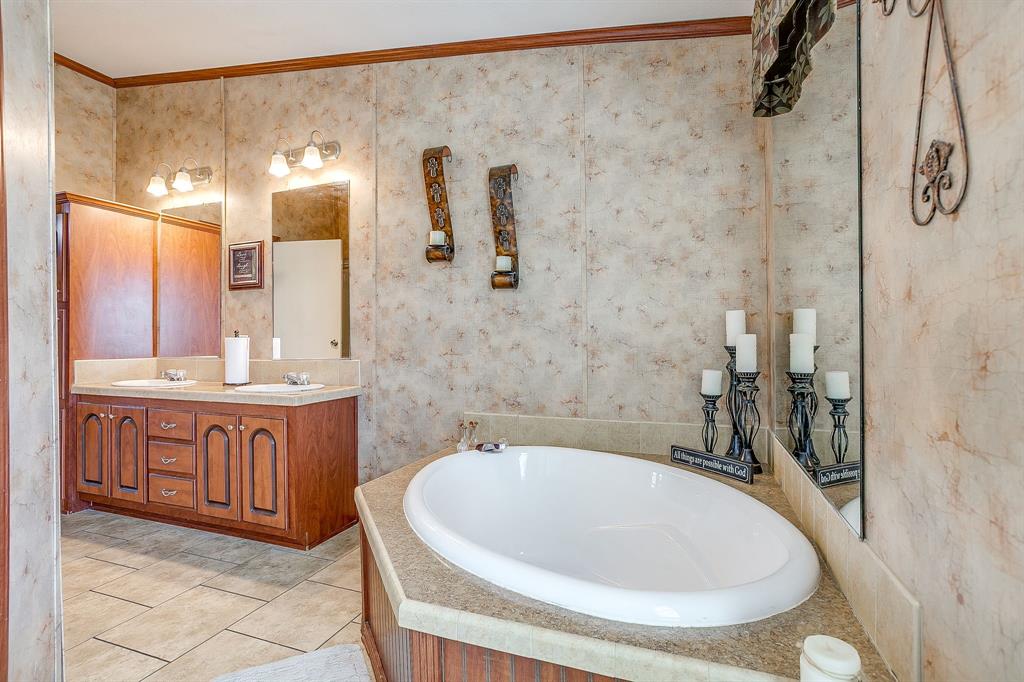 321 Young Road Millsap, TX 76066 - Photo 18 of 28 a bathroom with a tub sink and mirror