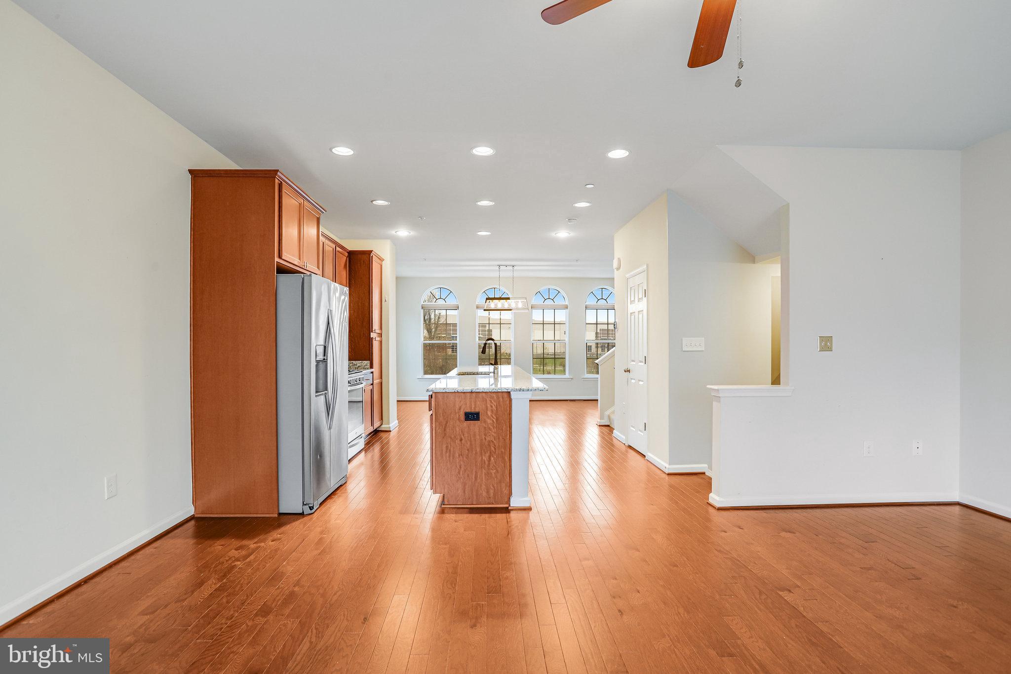 5918 Jefferson Commons Way Frederick, MD 21703 - Photo 11 of 39 a view of kitchen with stainless steel appliances refrigerator stove and wooden floor