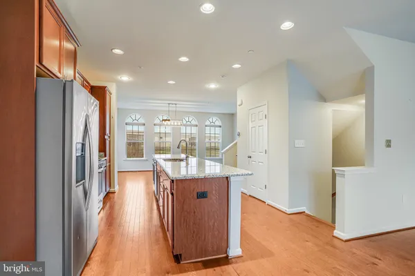 a kitchen with stainless steel appliances granite countertop a refrigerator and a stove