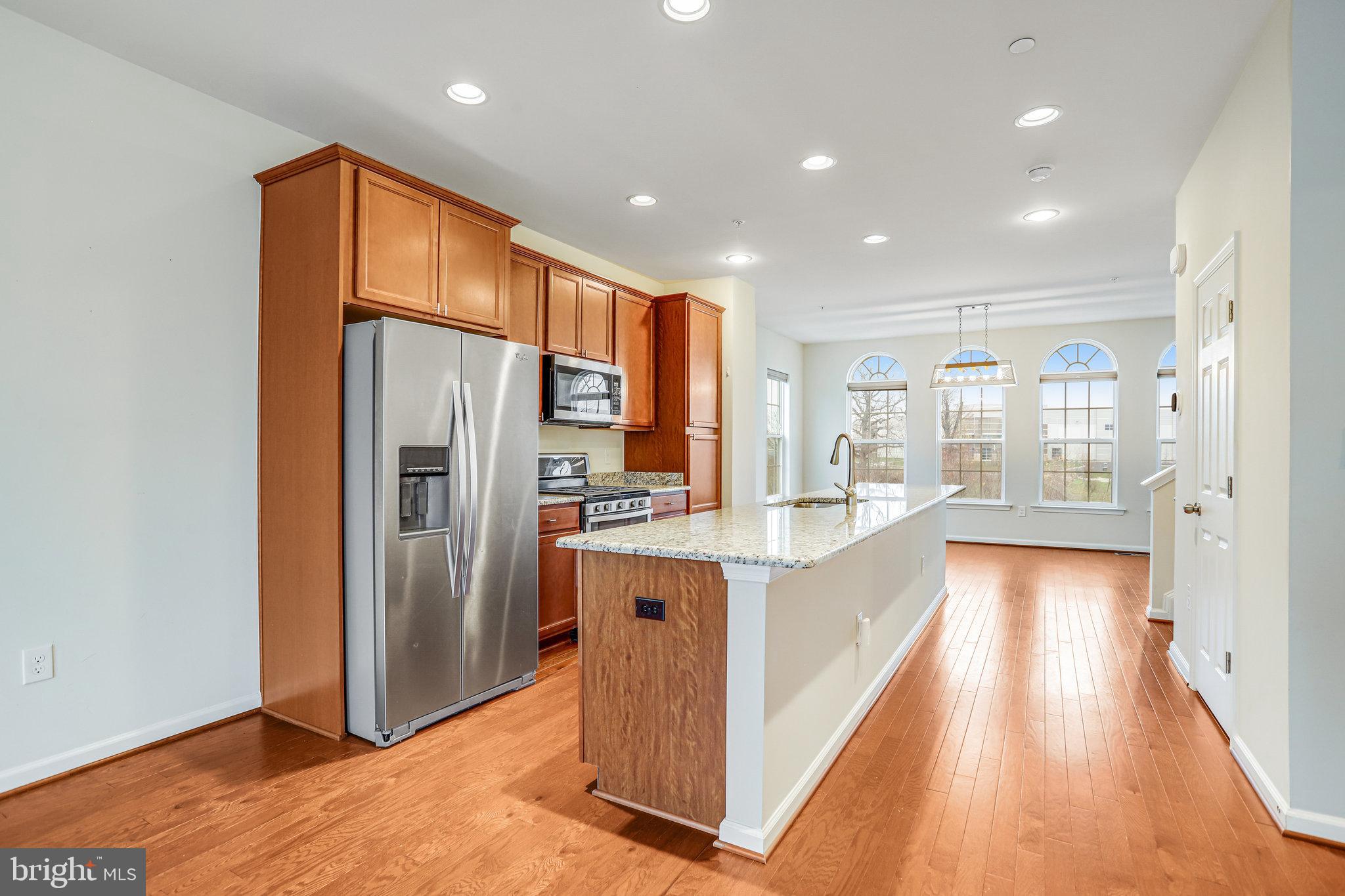 5918 Jefferson Commons Way Frederick, MD 21703 - Photo 14 of 39 a large kitchen with stainless steel appliances granite countertop a refrigerator and a sink