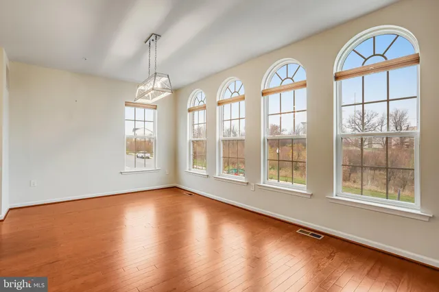 a view of an entryway with wooden floor and windows