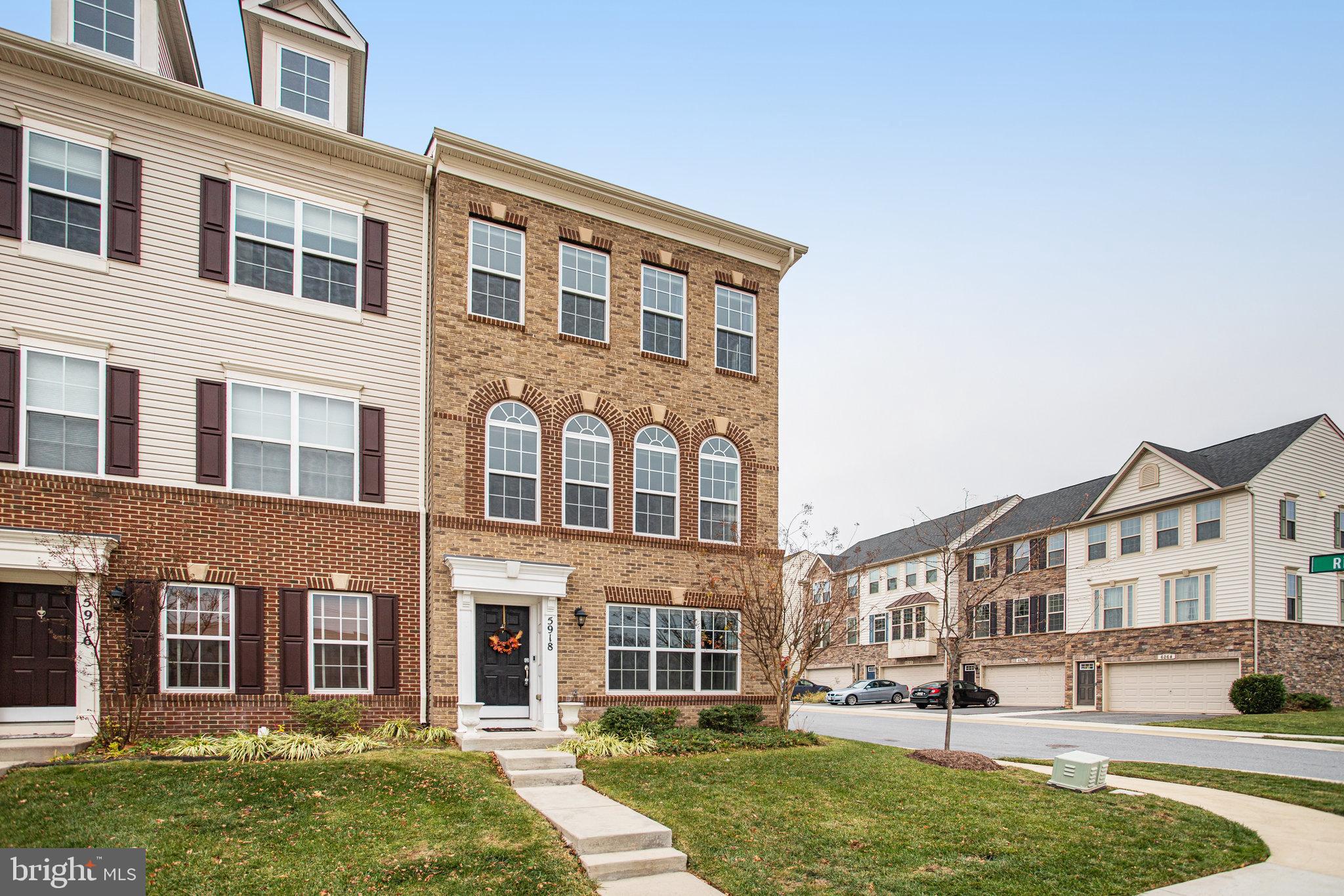5918 Jefferson Commons Way Frederick, MD 21703 - Photo 2 of 39 front view of a brick house with a yard