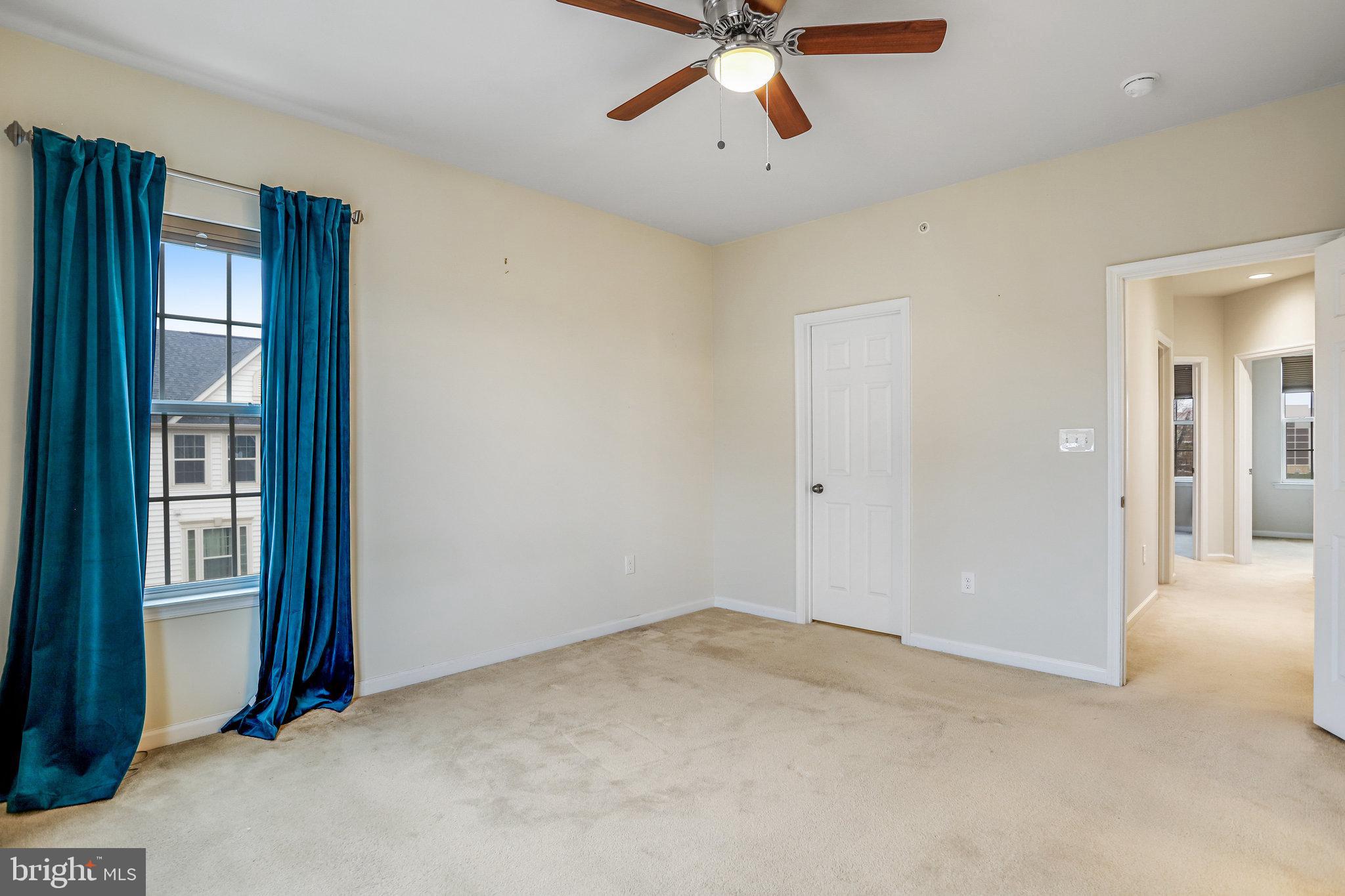 5918 Jefferson Commons Way Frederick, MD 21703 - Photo 23 of 39 an empty room with chandelier fan and windows