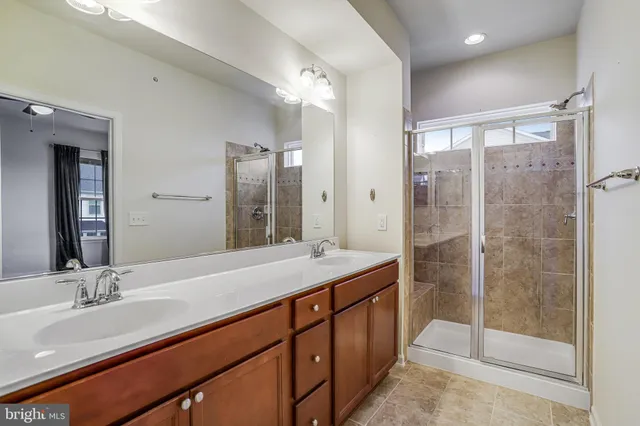 a bathroom with a shower sink and mirror