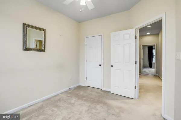 an empty room with closet and a bathroom