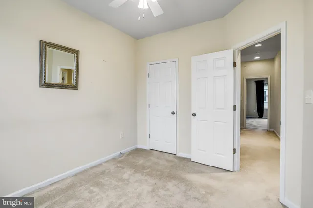 an empty room with closet and a bathroom