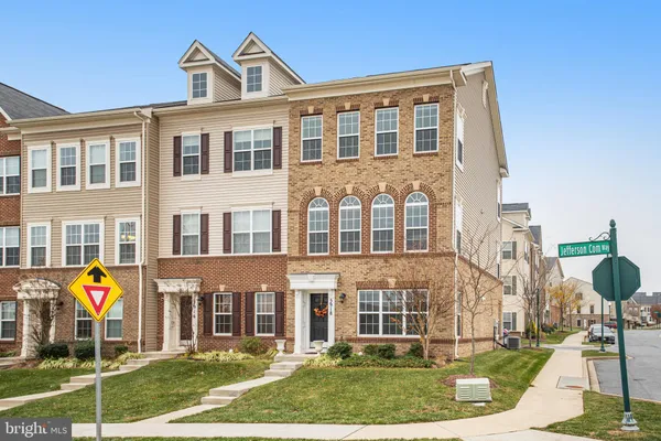 a front view of a residential apartment building with a yard
