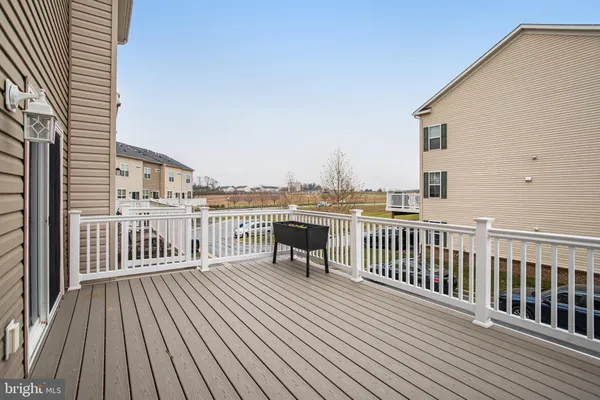 a view of a roof deck with wooden floor and fence