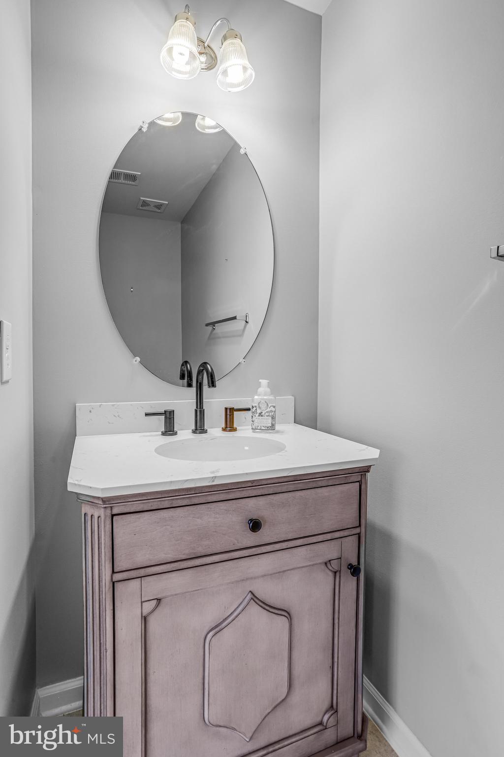 5918 Jefferson Commons Way Frederick, MD 21703 - Photo 7 of 39 a bathroom with a sink vanity and a mirror