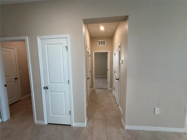 an empty room with a window and a ceiling fan