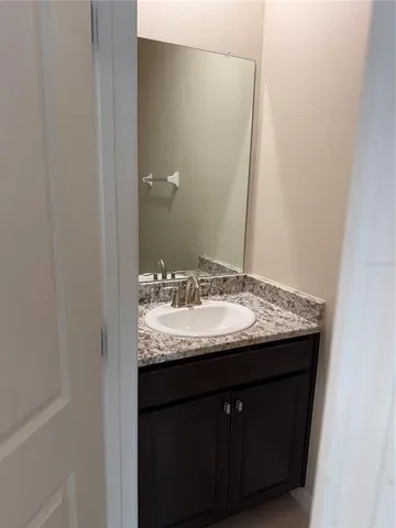 an empty room with closet and a chandelier fan