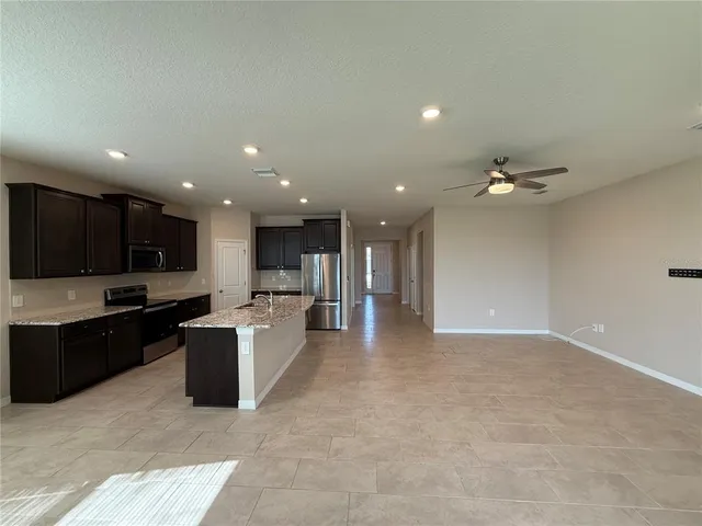 a view of kitchen with stainless steel appliances kitchen island