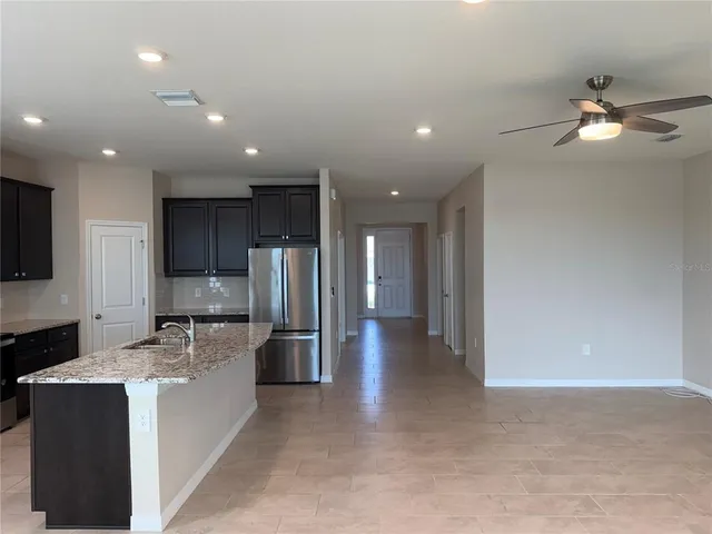 a large kitchen with stainless steel appliances lots of counter space and a refrigerator