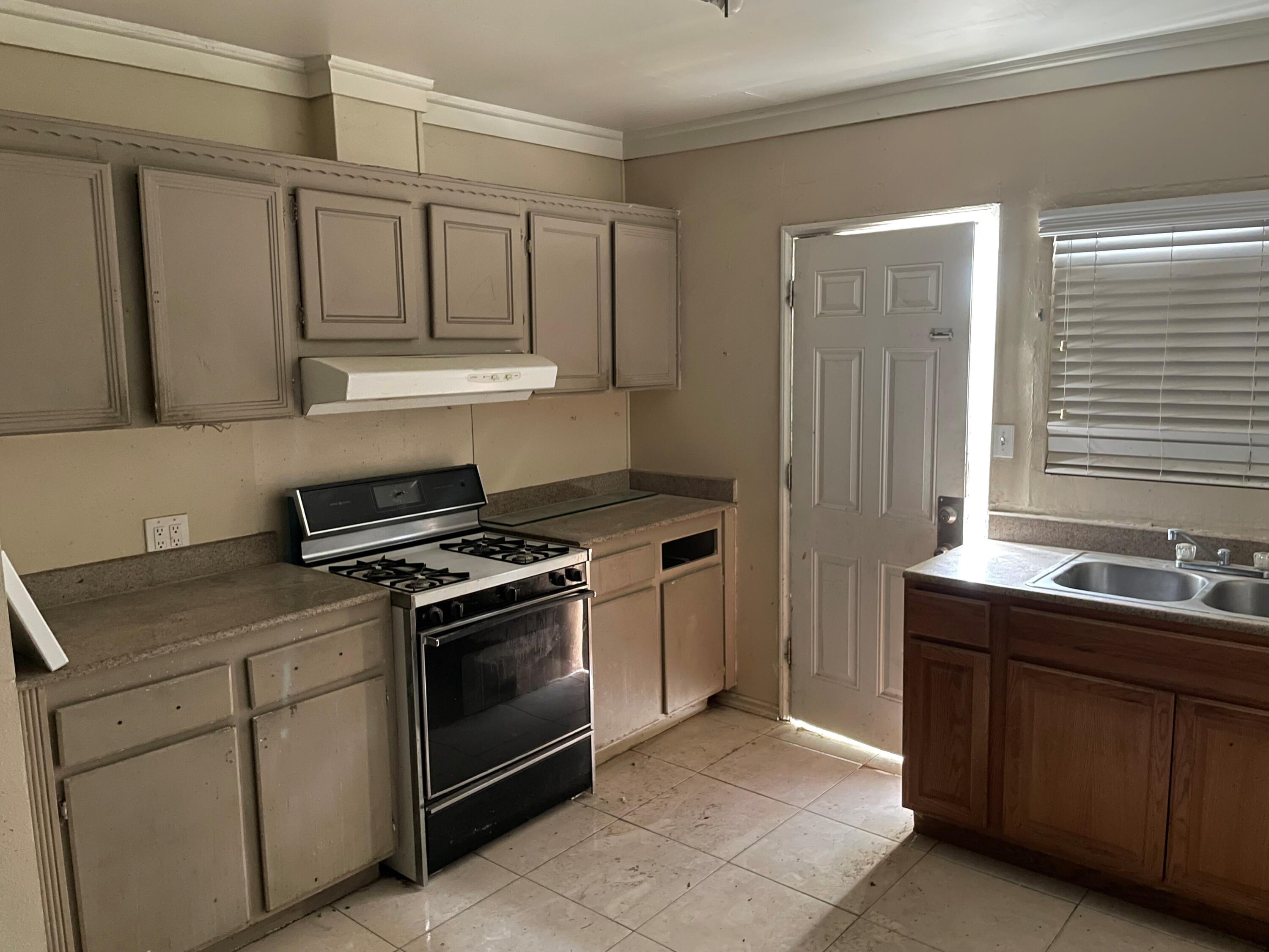 382 Iowa Avenue Riverside, CA 92507 - Photo 2 of 26 a kitchen with stainless steel appliances granite countertop a stove and a sink