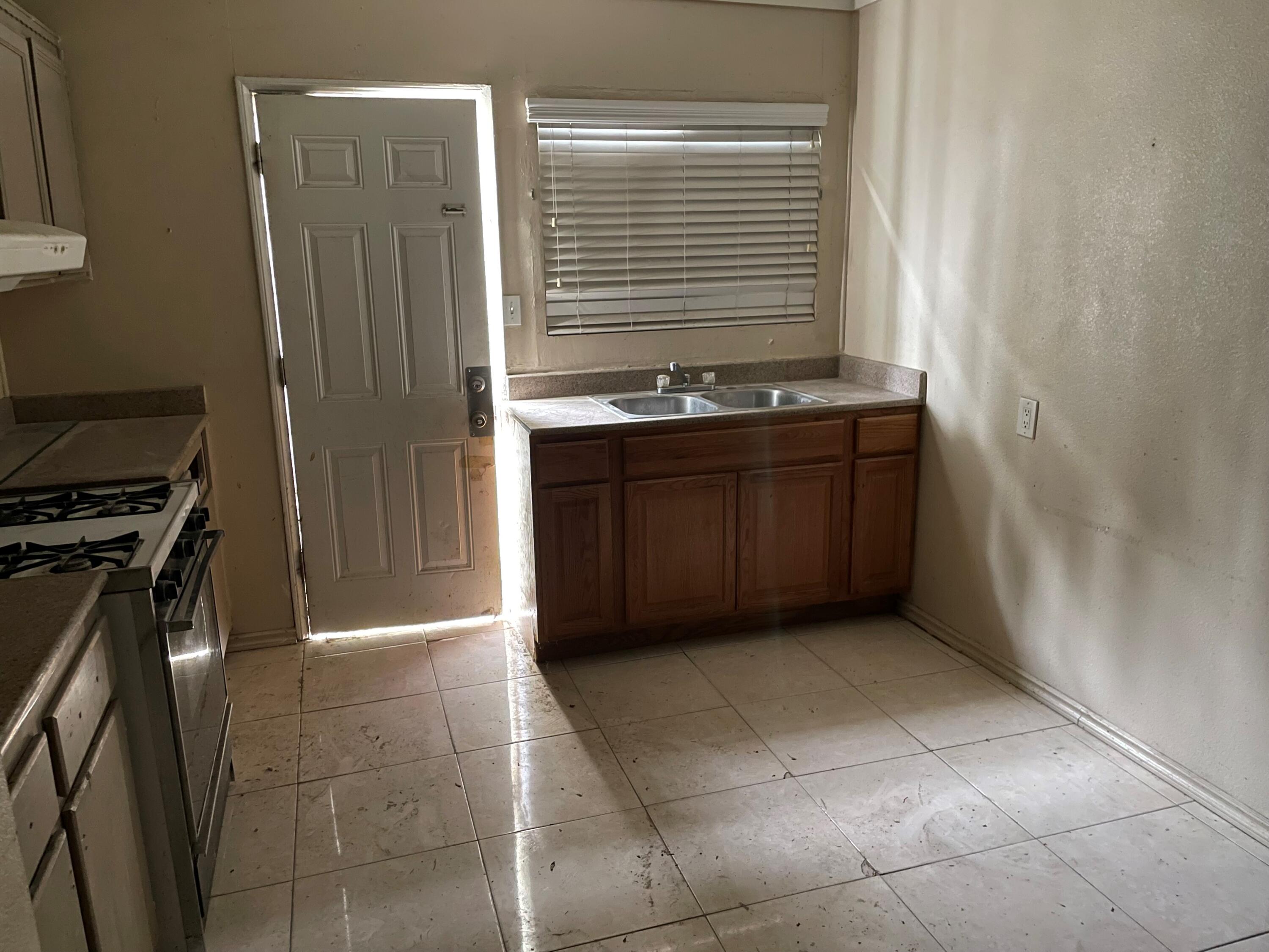 382 Iowa Avenue Riverside, CA 92507 - Photo 3 of 26 a bathroom with a granite countertop sink and a mirror