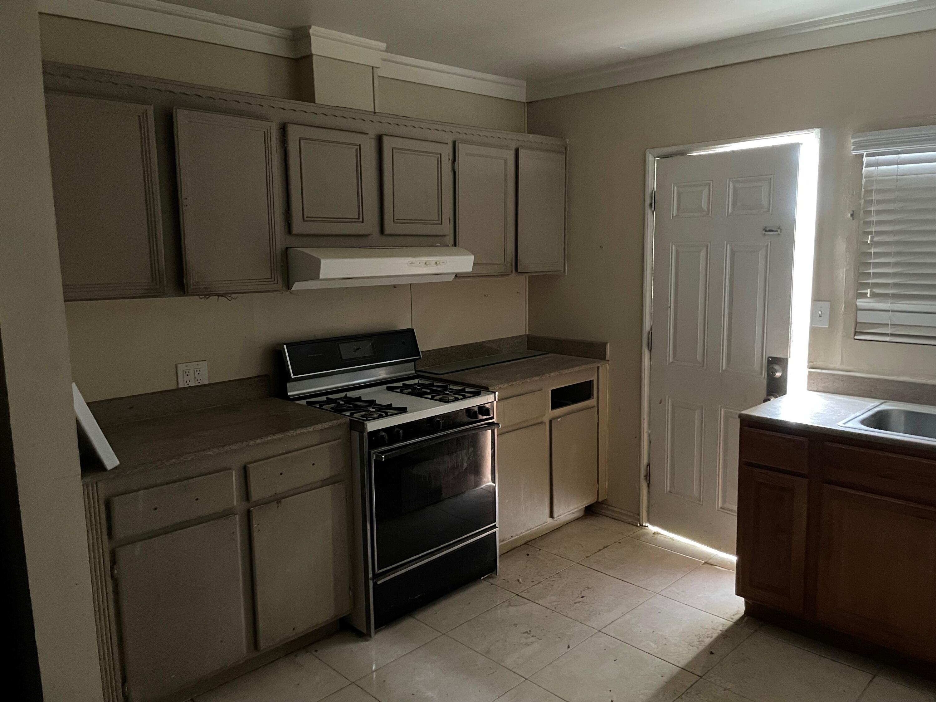 382 Iowa Avenue Riverside, CA 92507 - Photo 9 of 26 a kitchen with stainless steel appliances granite countertop a stove and a sink