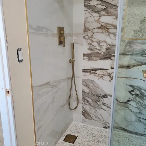 a bathroom with a glass shower door