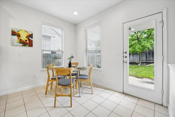 a dining room with furniture and a floor to ceiling window