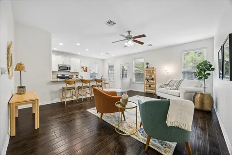 a living room with furniture a fireplace and a table