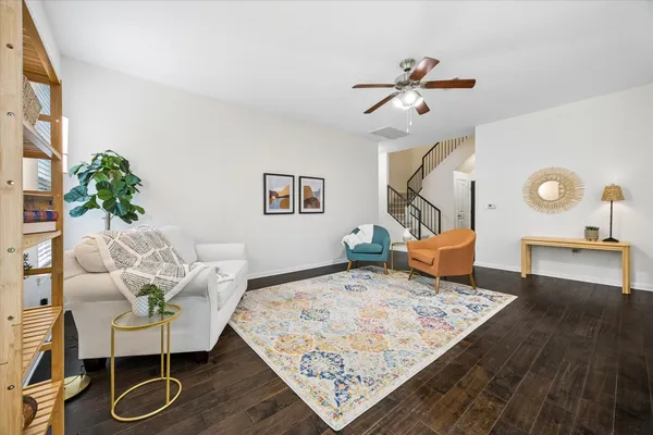 a living room with furniture and wooden floor