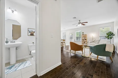 a living room with furniture and a wooden floor