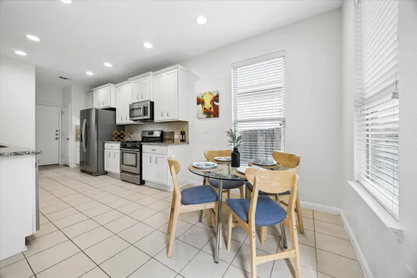 a view of kitchen with refrigerator and chairs