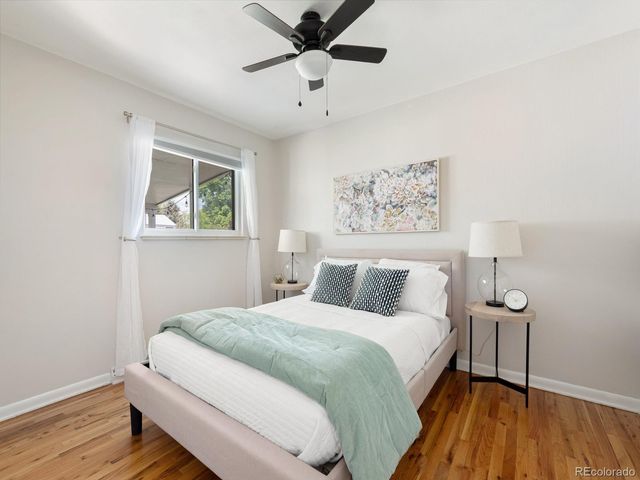 a bedroom with a bed and a painting on the wall