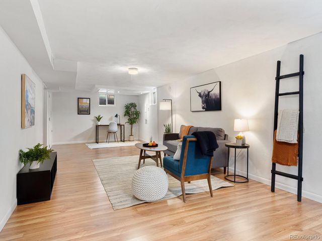 a living room with furniture and a potted plant