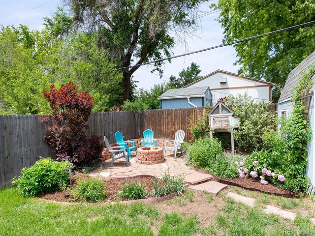 a view of garden with an outdoor seating