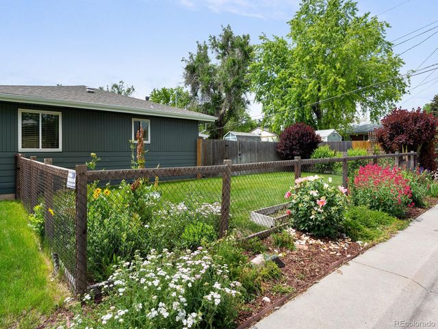 a backyard of a house with lots of green space and plants