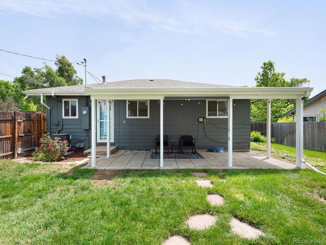 a view of a house with backyard sitting area and garden