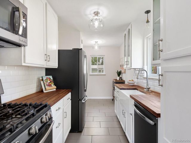 a kitchen with stainless steel appliances a sink stove and refrigerator
