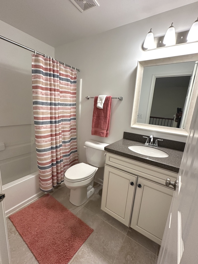 5102 Monroe Street Matteson, IL 60443 - Photo 42 of 54 a bathroom with a toilet a sink and a mirror