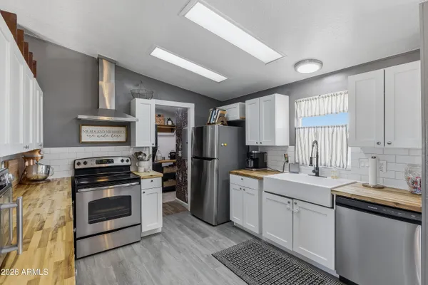 a kitchen with a sink stove and refrigerator