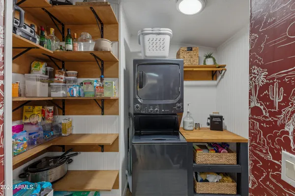 a kitchen with stainless steel appliances kitchen island granite countertop a sink dishwasher a dining table and chairs with wooden floor